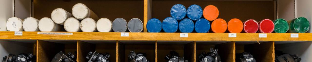Colorful cardboard circles and tripods in rows